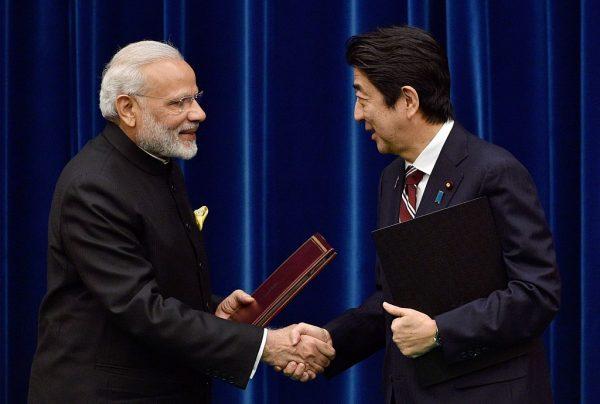 India's Prime Minister Narendra Modi (L) and his Japanese counterpart Shinzo Abe shake hands after signing in Tokyo on Nov. 11, 2016. (Franck Robichon/AFP/Getty Images)