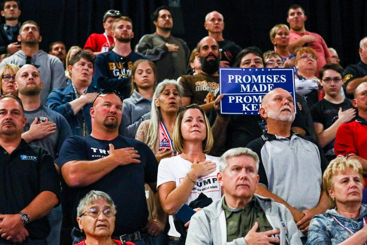 Audience members during the national anthem at a Make America Great Again rally in Wheeling, West Va., on Sept. 29, 2018. (Charlotte Cuthbertson The Epoch Times)
