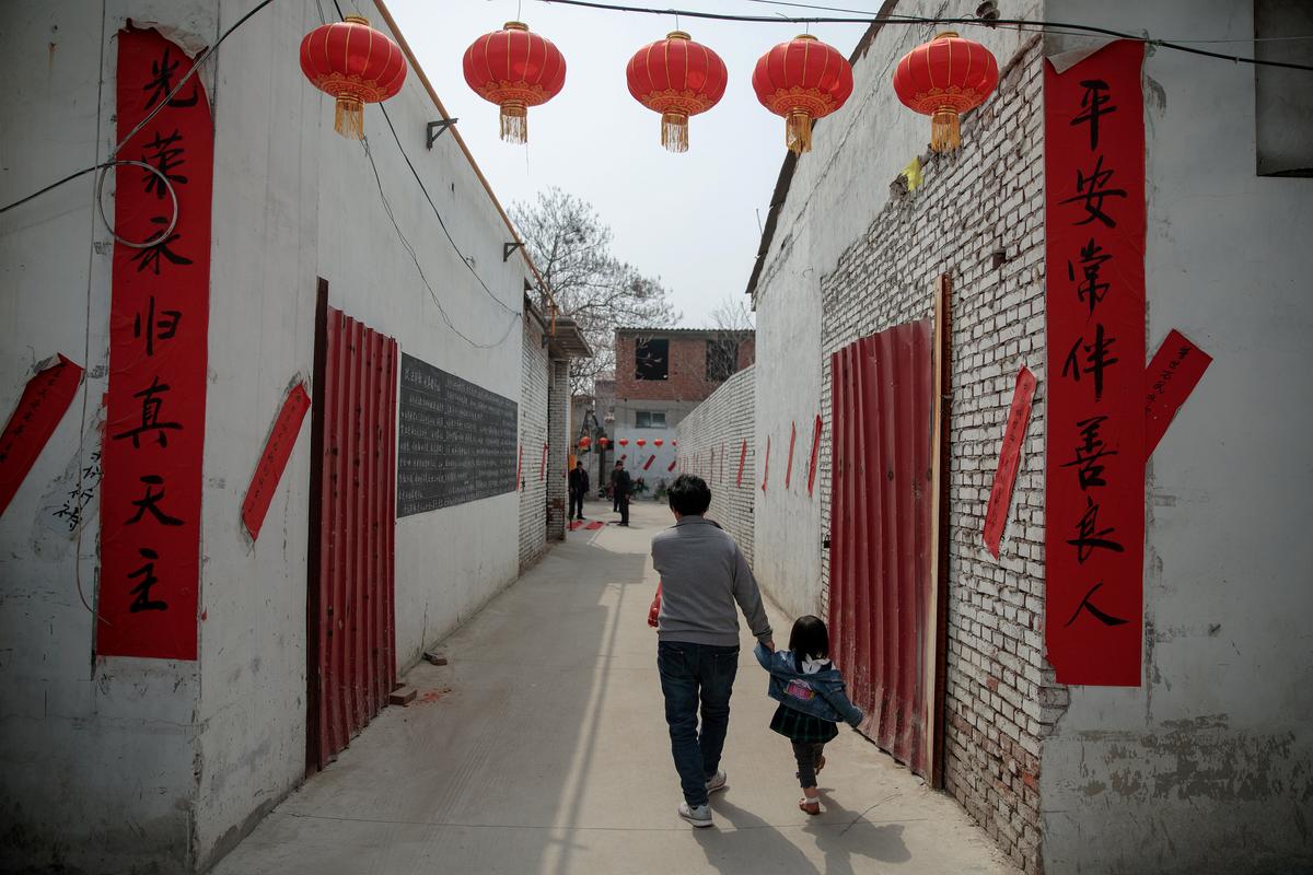 Banners with religious slogans are placed outside an "underground" Catholic church run by outspoken priest Dong Guanhua, as it is decorated for the Easter celebration in Youtong village, Hebei Province, China on March 31, 2018. (Damir Sagolj/Reuters)