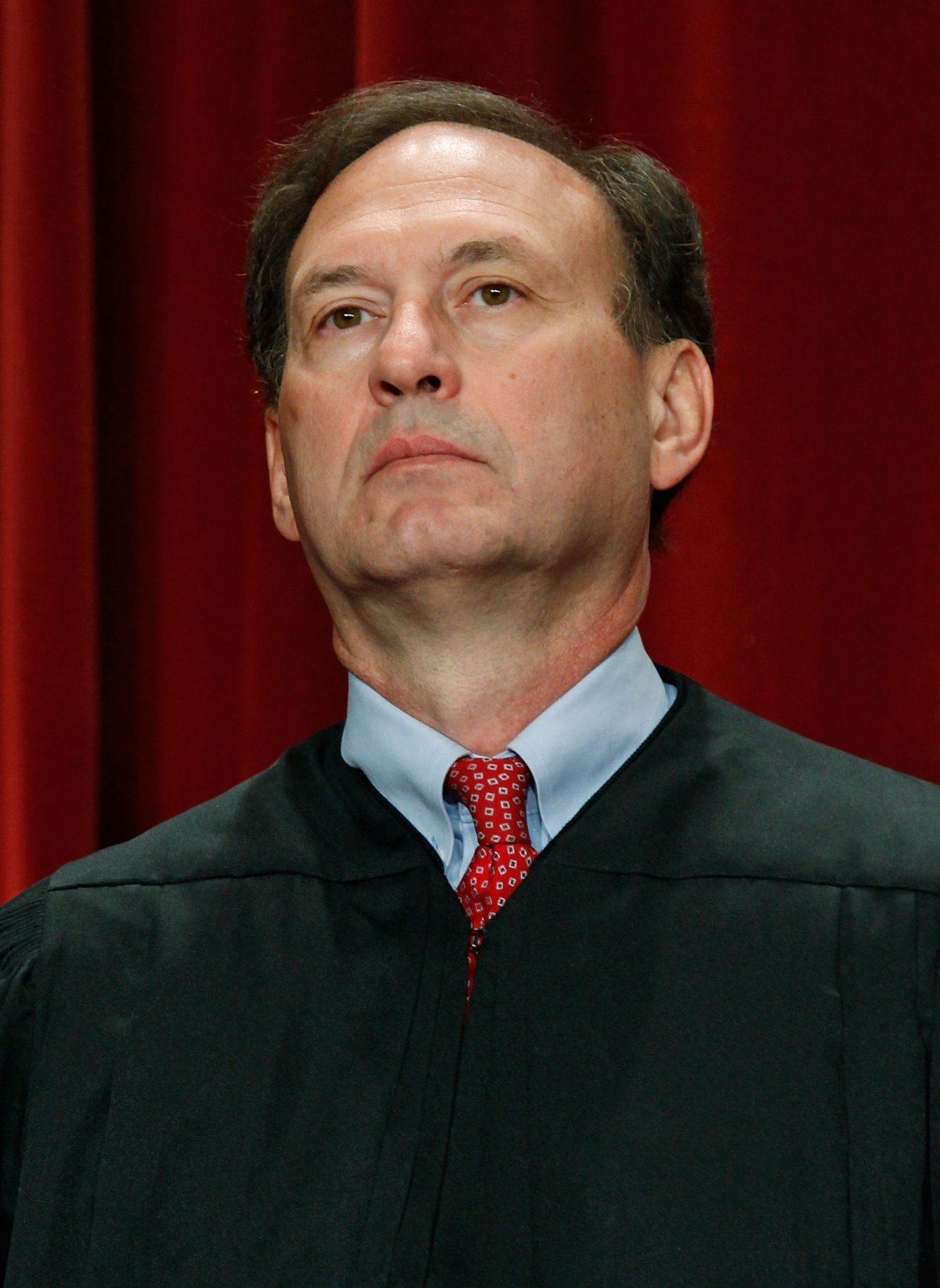 Associate Justice Samuel Alito poses during a group photograph at the Supreme Court building in Washington on Sept. 29, 2009. (Mark Wilson/Getty Images)