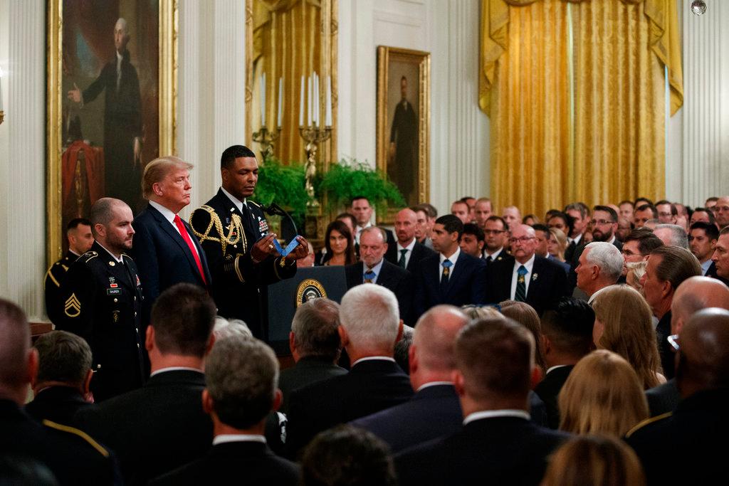 President Donald Trump stands with former Army Staff Sgt. Ronald J. Shurer II before presenting him with the Congressional Medal of Honor for actions in Afghanistan, in the East Room of the White House, in Washington on Oct. 1, 2018. (Evan Vucci/AP)