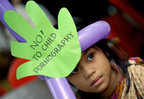 A grade school girl takes part in a Manila public forum on child pornography, also attended by UN officials and local movie actors in Manila on June 5, 2009.  (Jay Directo/AFP/Getty Images)