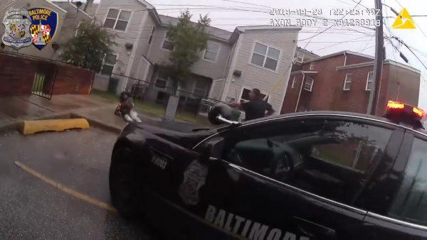 Baltimore Police Officer Phillip Lippe talks to a suspect on the ground, on Sept. 23, 2018. (Baltimore Police Department)