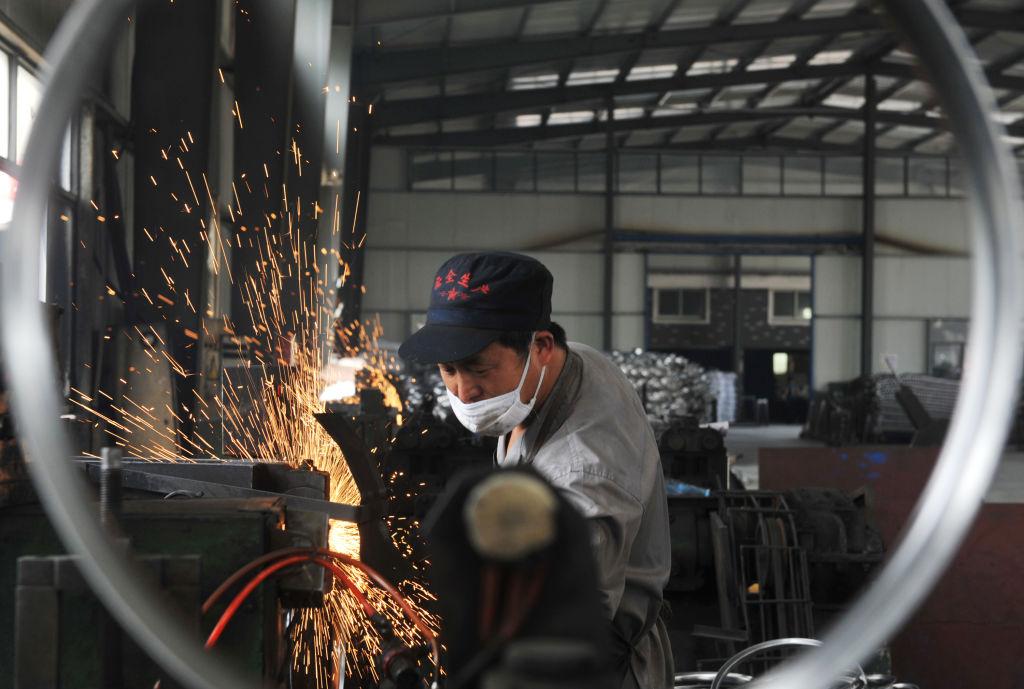 A worker welds wheel hubs of baby carriages that will be exported at a factory in Hangzhou in China's eastern Zhejiang Province on June 4, 2018. (AFP/Getty Images)