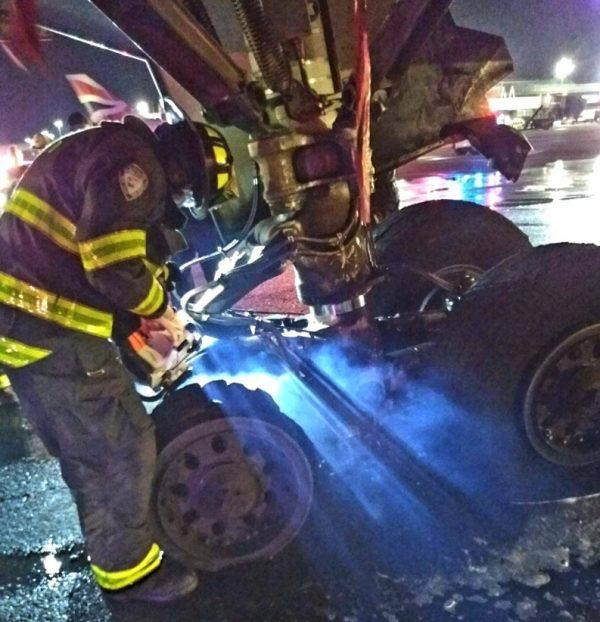 Aircraft rescue Firefighter units inspect the landing gear of the Delta plane at JFK Airport, in New York, on Oct. 1, 2018. (Port Authority PBA)