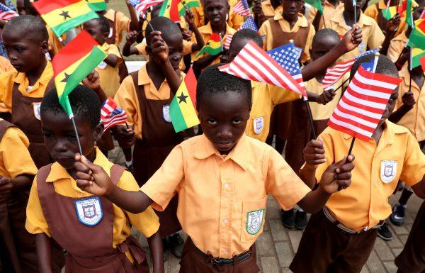 Children carry flags as they greet U.S. first lady Melania Trump on arrival in Accra, Ghana, on Oct. 2, 2018. (Carlo Allegri/Reuters)