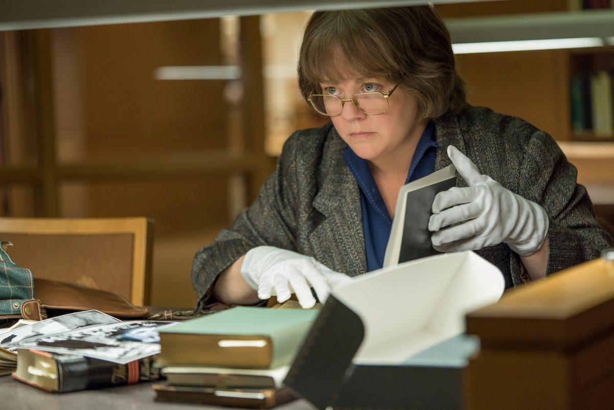 Lee Israel (Melissa McCarthy) stealing original letters while pretending to do research in the film “Can You Ever Forgive Me?” (Mary Cybulski/Twentieth Century Fox Film Corporation)