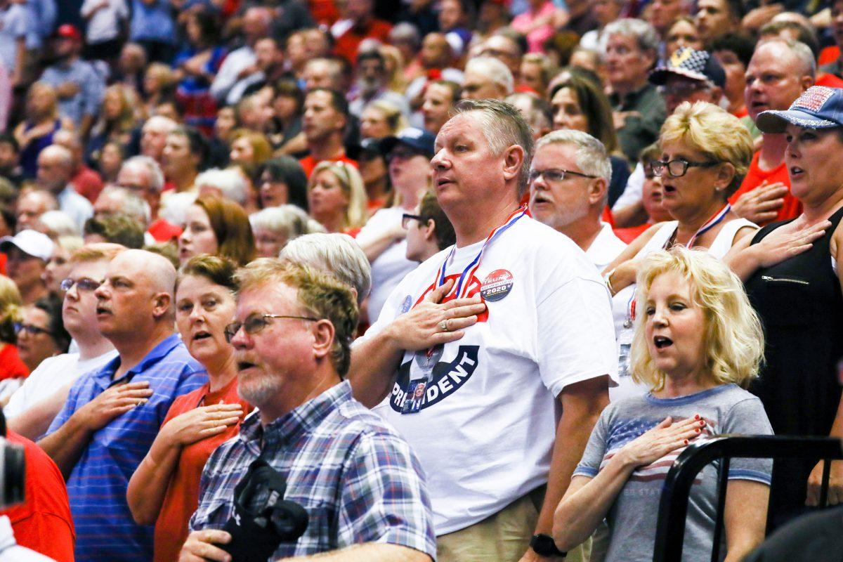 Attendees recite the Pledge of Allegiance at a Make America Great Again rally in Southaven, Miss., on Oct. 2, 2018. (Charlotte Cuthbertson/The Epoch Times)