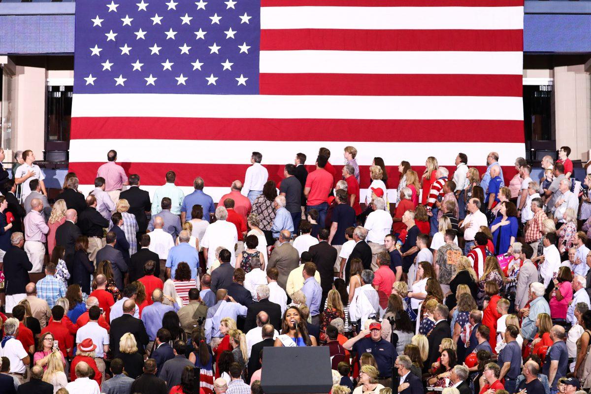 Miss Mississippi Asya Branch sings the national anthem at a Make America Great Again rally in Southaven, Miss., on Oct. 2, 2018. (Charlotte Cuthbertson/The Epoch Times)