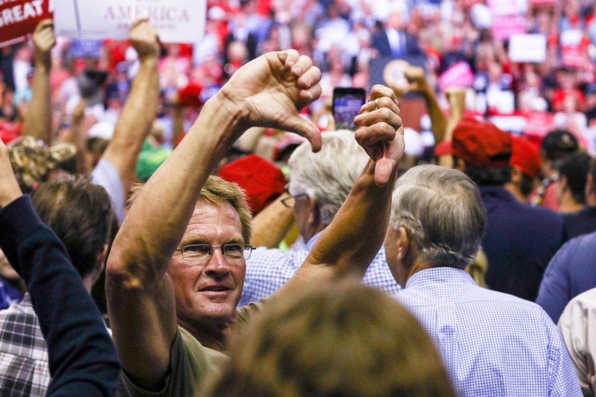 Attendees boo the media at a Make America Great Again rally in Southaven, Miss., on Oct. 2, 2018. (Charlotte Cuthbertson/The Epoch Times)