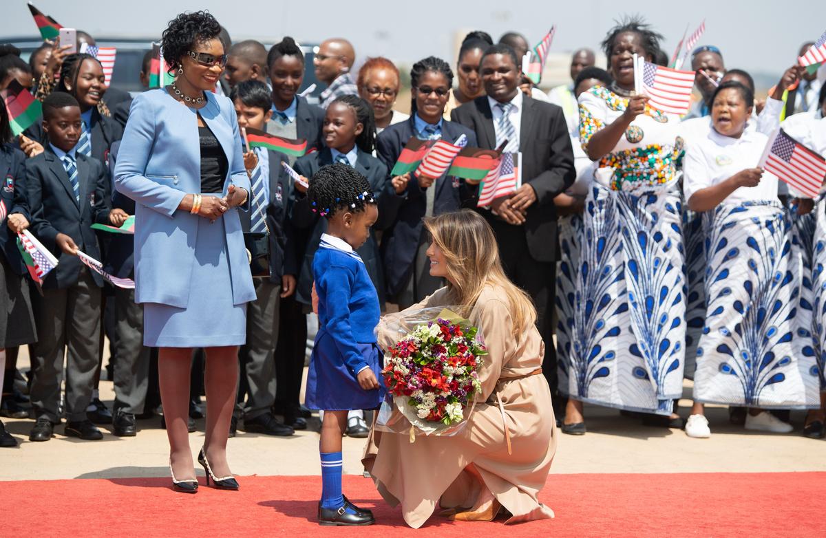 First Lady Melania Trump (R) receives flowers from a young girl alongside the first lady of Malawi, Gertrude Maseko (L), as she arrives at Lilongwe International Airport on Oct. 4. (Saul Loeb/AFP/Getty Images)