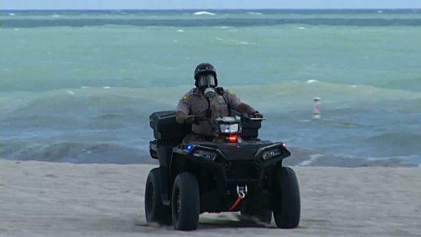 A Miami-Dade police officer is seen wearing a gas mask and riding an ATV in Miami Beach, Fla., on Oct. 4, 2018. (Josh Replogle/AP)