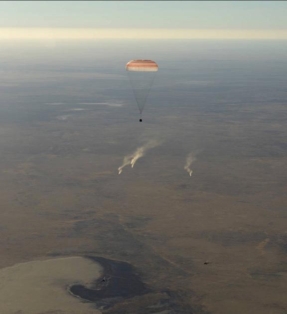 The landing jets fire as the Soyuz MS-08 spacecraft comes in for a landing on Oct. 4, 2018, in Kazakhstan. (Bill Ingalls/NASA)