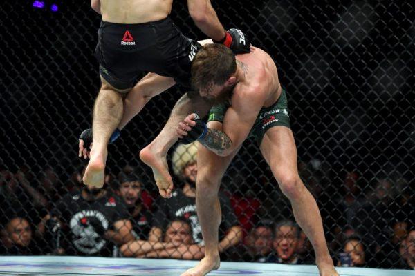 Nurmagomedov (red-banded gloves) leaps towards Conor McGregor during UFC 229 at T-Mobile Arena, Oct 6, 2018, Las Vegas. (Stephen R. Sylvanie-USA TODAY Sports)