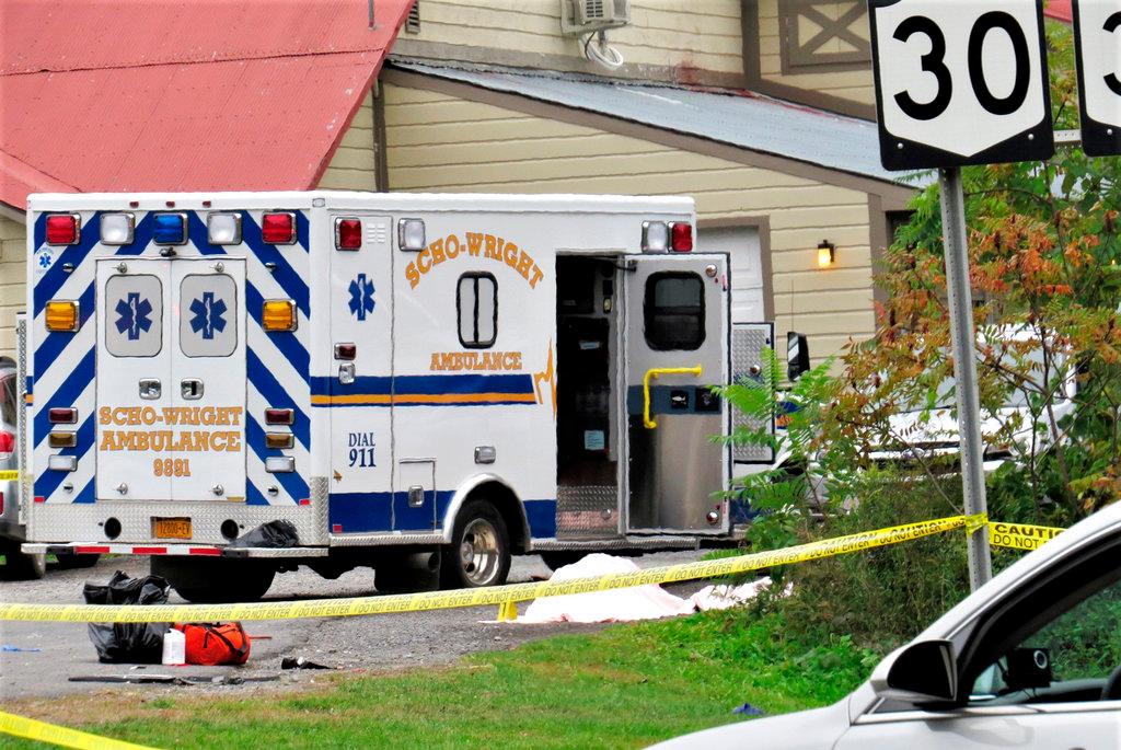 A body is draped under a blanket at the scene of a fatal crash in Schoharie, N.Y on Oct. 8, 2018. (Tom Heffernan Sr. via AP)