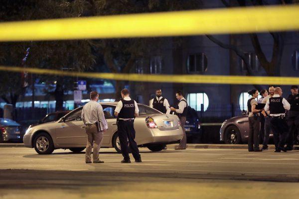 Police investigate the scene of a shooting near the Chinatown neighborhood in Chicago where four people were shot in an apparent road rage incident on Sept. 19, 2018. A 6-month-old boy and a 13-year-old girl were among the victims. (Scott Olson/Getty Images)