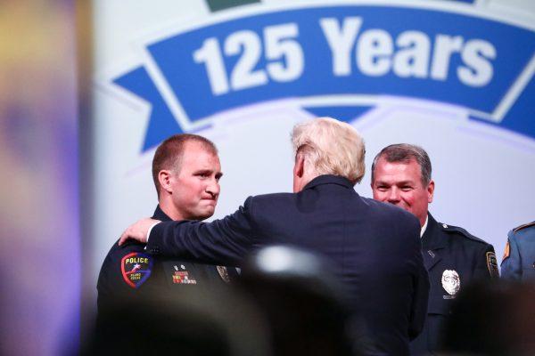 President Donald Trump thanks two of the Target Officer of the Year finalists, officers Taylor Rust (L) and Mark Dallas, at the International Association of Chiefs of Police convention in Orlando, Fla., on Oct. 8, 2018. (Charlotte Cuthbertson/The Epoch Times)