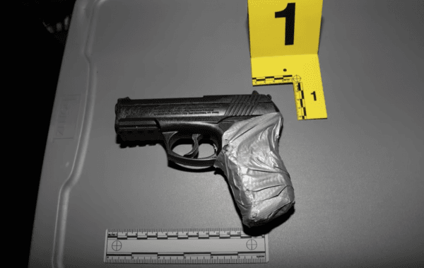 The replica handgun picked up by an officer was a CO2 powered BB pistol. (Screenshot/LAPD)