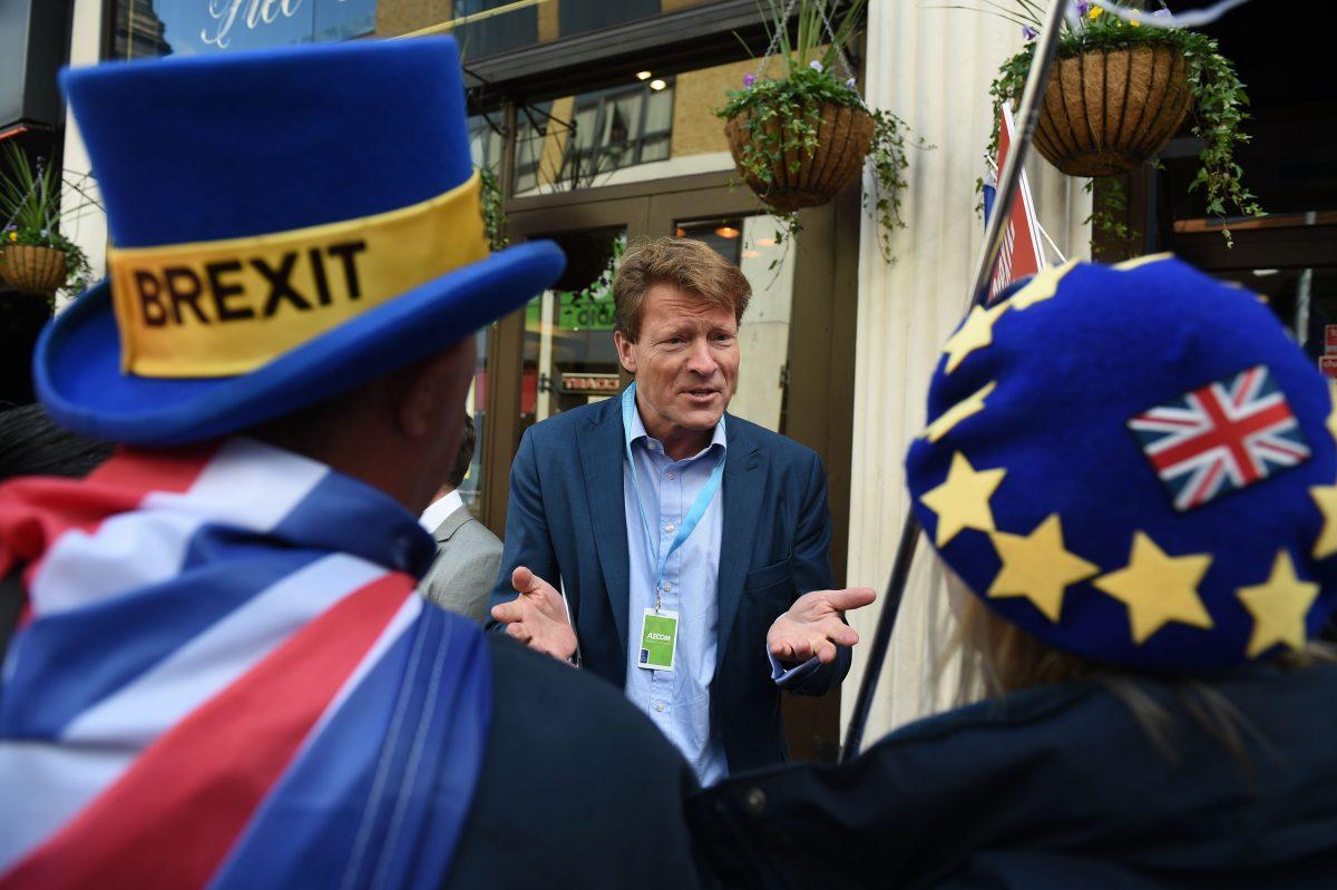 The 'Leave Means Leave' Brexit campaign Co-chair Richard Tice (C) talks to anti-Brexit activists a fringe event at the Conservative Party Conference in Birmingham, England, on Oct. 1, 2018. (Oli Scarff/ AFP/Getty Images)