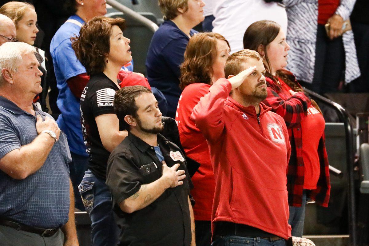 Attendees during the national anthem at a Make America Great Again rally in Council Bluffs, Iowa, on Oct. 9, 2018. (Charlotte Cuthbertson/The Epoch Times)