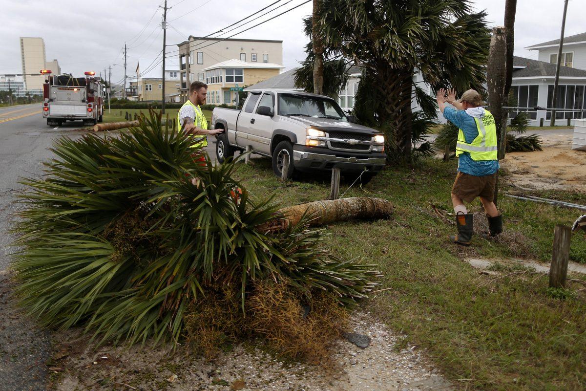 Emergency crews work to clear a street of debris during Hurricane Michael in Panama City Beach, Florida, on Oct. 10, 2018. (Jonathan Bachman/Reuters)