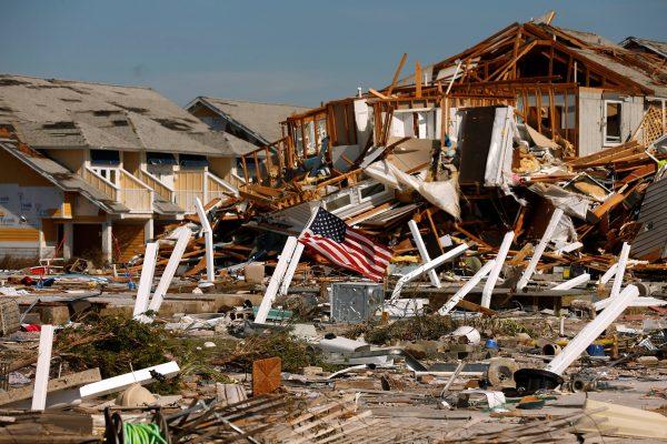 An American flag flies amongst rubble left in the aftermath of Hurricane Michael in Mexico Beach, Fla., on Oct. 11, 2018. (Jonathan Bachman/Reuters)
