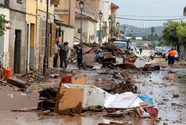 Debris strewed a street in Sant Llorenc, Oct. 10, 2018. (Enrique Calvo/Reuters)