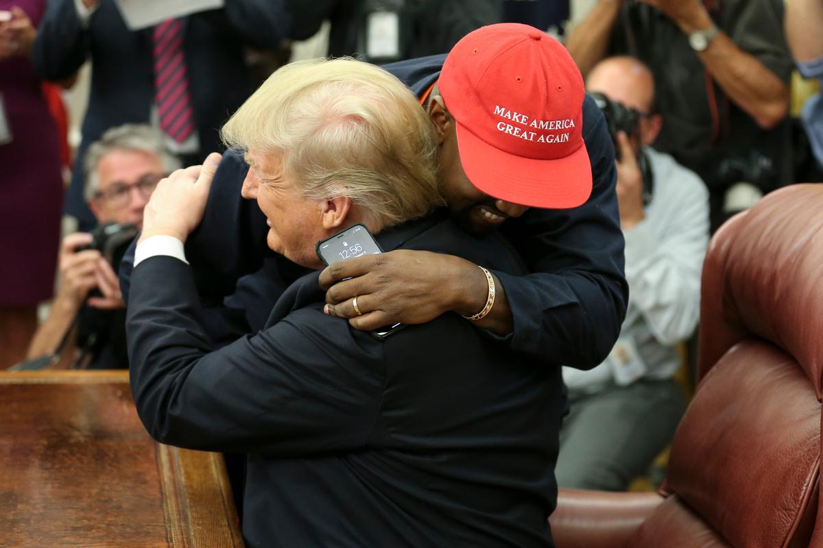 President Donald Trump hugs rapper Kanye West during a meeting in the Oval Office of the White House in Washington on Oct. 11, 2018. (Oliver Contreras - Pool/Getty Images)
