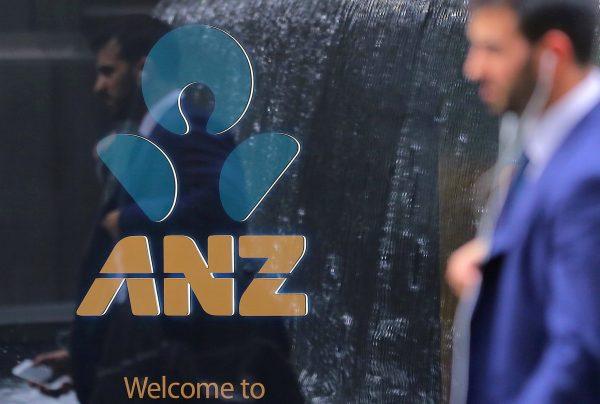 A pedestrian is reflected in the window of a branch of the Australia and New Zealand Banking Group (ANZ) in CENTRAL SYDNEY, Australia, Oct. 25, 2017. (Steven Saphore/Reuters)