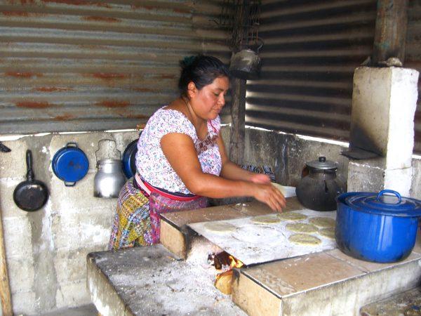 A local cooking tortillas on a wood-fired stove. (Susan Korah)
