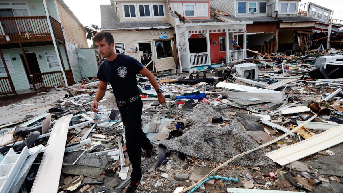 Firefighter Austin Schlarb performs a door to door search in the aftermath of Hurricane Michael in Mexico Beach, Fla., on Oct. 11, 2018. (Gerald Herbert/AP)