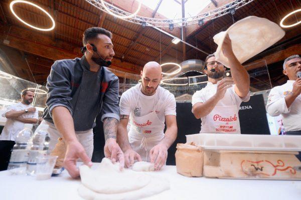 Pizza chefs perform during a cooking show at the “Festival della Pizza e Mozzarella” in Bologna, Italy, on Aug. 29, 2018. (Roberto Serra/Iguana Press/Getty Images)