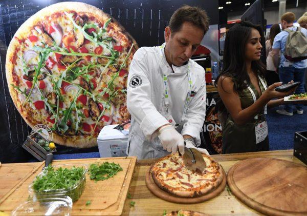 File photo of a pizza chef at work during the Western Foodservice and Hospitality Expo in Los Angeles, on Aug. 19, 2018. (Mark Ralston/AFP/Getty Images)