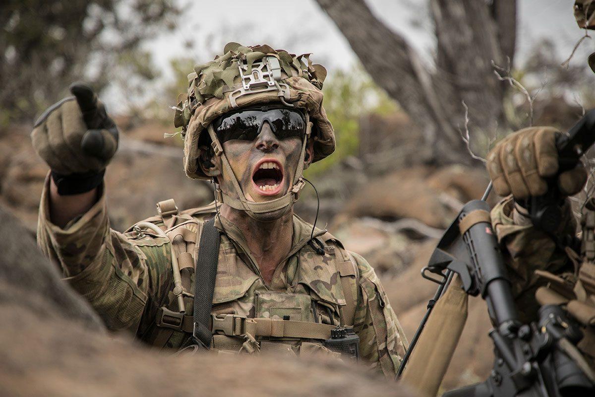 A soldier assigned to the 25th Infantry Division signals his platoon during a Combined Arms Live Fire Exercise at the Pohakuloa Training Area in Hawaii on May 15, 2018. (U.S. Army photo by 1st Lt. Ryan DeBooy)