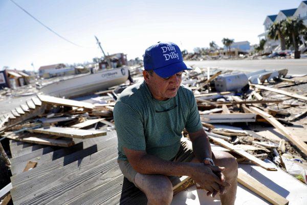 Hector Morales sits on a debris pile near his home which was destroyed by Hurricane Michael in Mexico Beach, Fla., on Oct. 12, 2018. (David Goldman/AP)