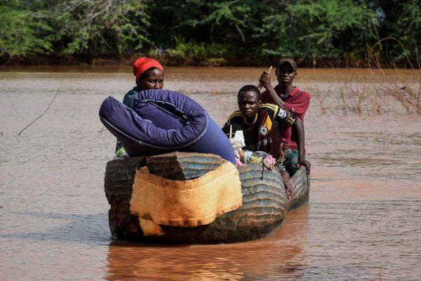 People move with their belongings on a boat in Dima village after the Tana River overflowed in coastal region of Kenya, on May 14, 2018. (Brian Ongoro/AFP/Getty Images)