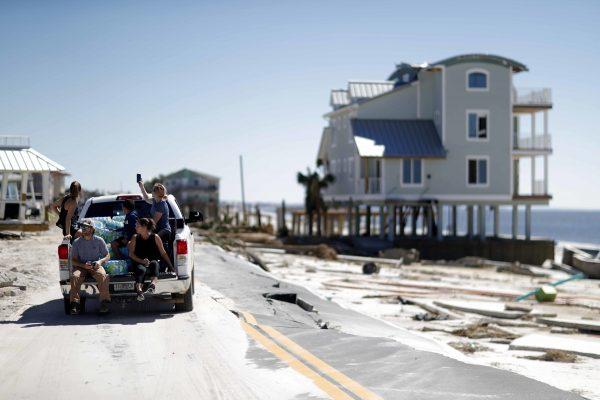 People drive along a damaged road in the aftermath of hurricane Michael in Mexico Beach, Fla., on Oct. 12, 2018. (David Goldman/AP)