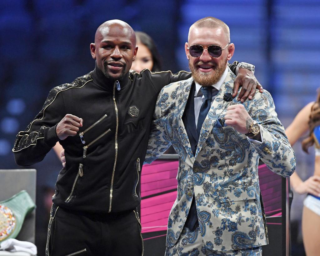 Floyd Mayweather Jr. (L) and Conor McGregor pose for pictures during a news conference after Mayweather's 10th-round TKO victory in their super welterweight boxing match on Aug. 26, 2017, at T-Mobile Arena in Las Vegas, Nevada. (Ethan Miller/Getty Images)