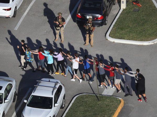 People are brought out of the Marjory Stoneman Douglas High School after a shooting at the school left 17 people dead on Feb. 14, 2018, in Parkland, Fla. (Joe Raedle/Getty Images)