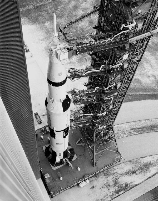 Apollo 6 and its gantry leaving the vehicle assembly building (VAB) on transporter heading to the launch site on pad 39A at KSC on Feb. 6, 1968. (NASA)