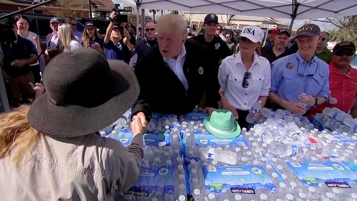 President Donald Trump and First Lady Melania Trump hand out bottles of water as they tour damage from Hurricane Michael in Lynn Haven, Fla., on Oc. 15, 2018. (Screenshot/AP)