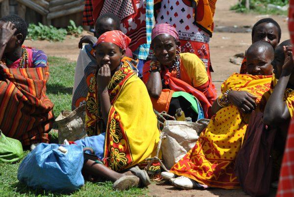 Women sit while waiting for their husbands to sell cattle or goats and give them money to buy food at Naikarra market in Narok County in Kenya on May 4, 2018. (Dominic Kirui/Special to The Epoch Times)