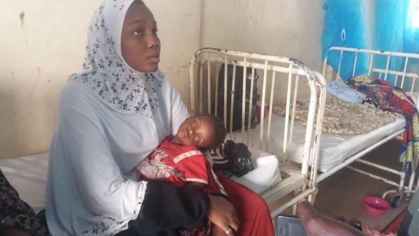 A woman holds her sick child as she waits for a doctor at the Hasiya Bayero Paediatric Hospital, Kano, Nigeria, in this file photo. (Toluwani Aniola/Special to The Epoch Times)