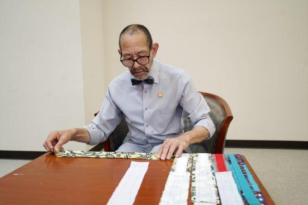 Gregory Bruce working with fabric. (Shenghua Sung/The Epoch Times)