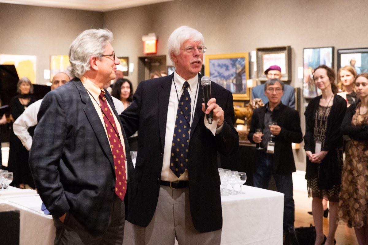 Art collector and chairman of the board of the Salmagundi Club, Tim Newton (R) with his friend, the artist Del-Bourree Bach, giving remarks at the opening of the American Masters Gala and Sale in the Salmagundi Club's Main Gallery on Oct. 12, 2018. (Milene Fernandez/The Epoch Times)