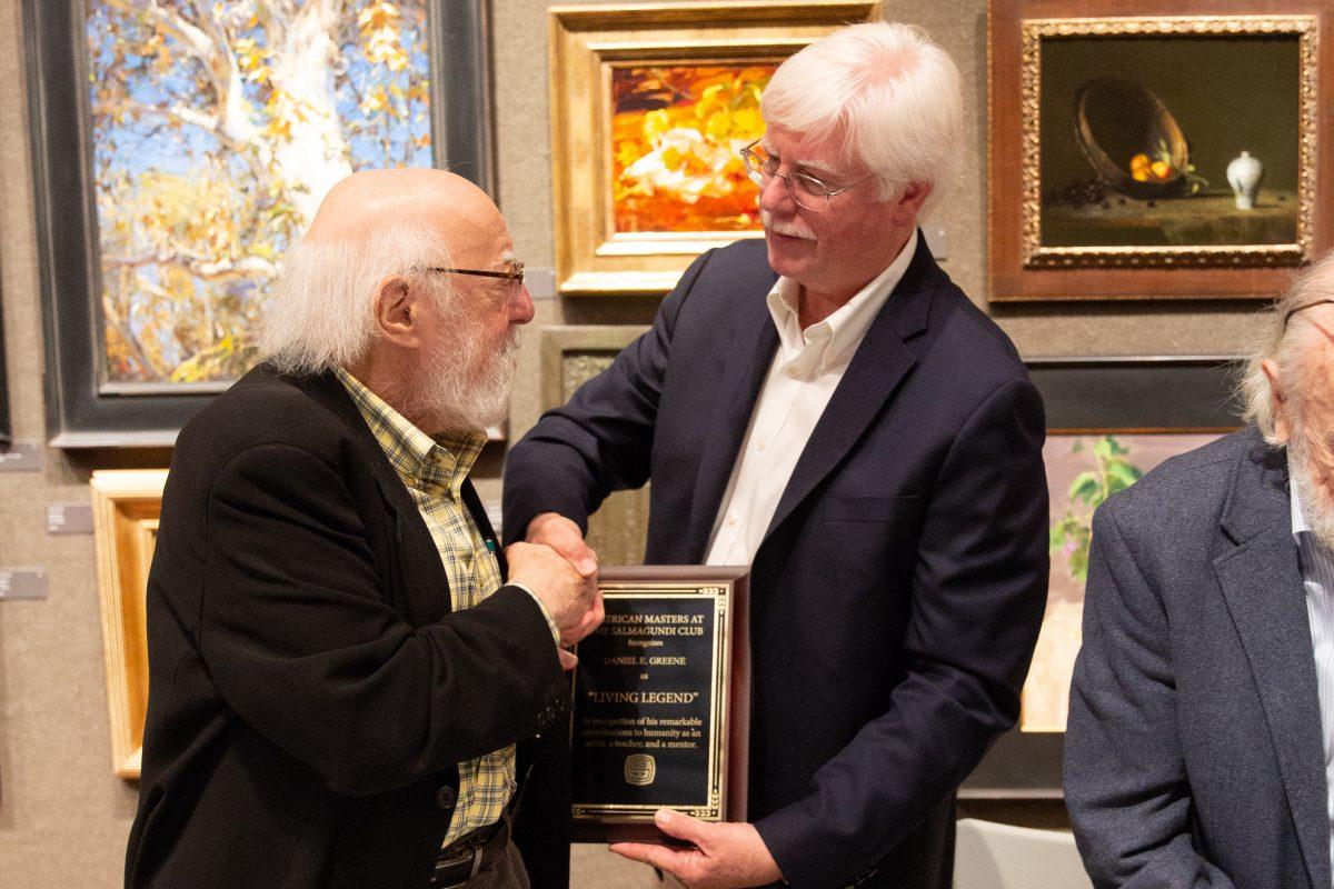 Tim Newton presents Daniel E. Greene with a lifetime achievement award as part of the Living Legends Live event during the 10th American Masters at the Salmagundi Club on Oct. 13, 2018. (Milene Fernandez/The Epoch Times)