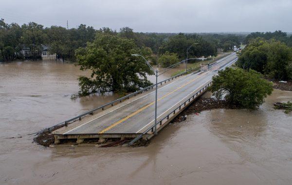 The Llano River flows past one side of Ranch Road 2900 bridge after the bridge was washed out due to flooding in Kingsland, Texas, on Oct. 16, 2018. (Jay Janner/Austin American-Statesman/AP)