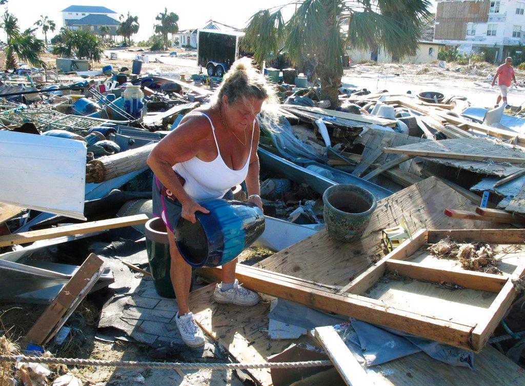 Dena Frost salvages an unbroken clay pot from the wreckage of her pottery business in Mexico Beach, Fla. on Oct. 14, 2018. (Russ Bynum/AP Photo)