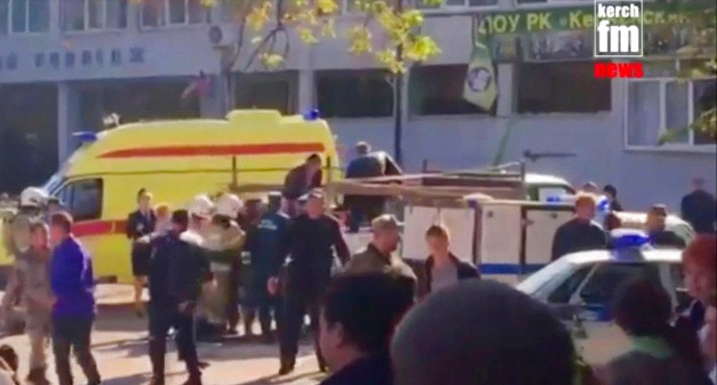 In this image made from video, showing the scene as emergency services load an injured person onto a truck, in Kerch, Crimea, after a shooting at a college on Wednesday Oct. 17, 2018. (Kerch FM News via AP)