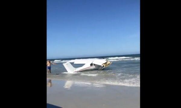 A plane rests at the water's edge on Daytona Beach Shores, after crashing in the ocean on Oct. 16, 2018. (Daytona Beach Shores DPS via Storyful)